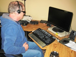 Green at desk with tech gear