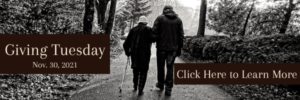 Photo of two people walking in the woods. Text says "Giving Tuesday Nov. 30 2021 Click Here to Learn More