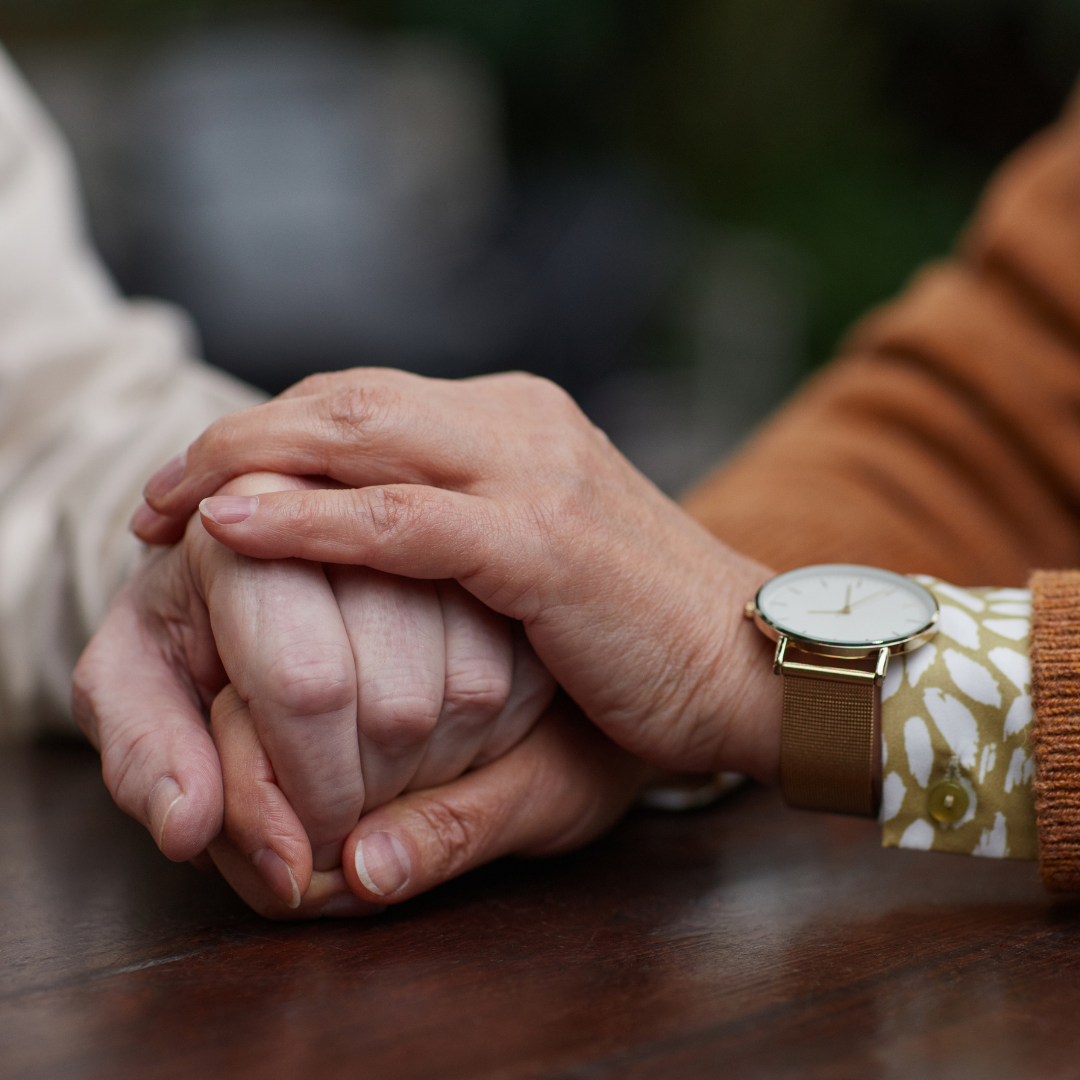 A hand holding another hand.