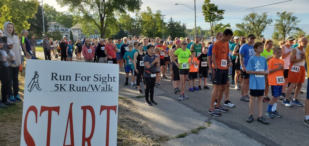 a group of people lined up at the start of a race for a 5k