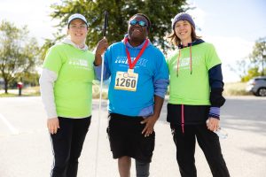 three people standing at Run for Site event